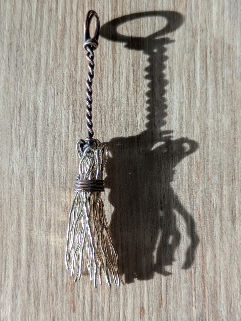 Broom pendant with twisted broom's stick