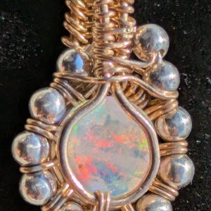 Close-up of Sunlit Facet handmade faceted opal pendant